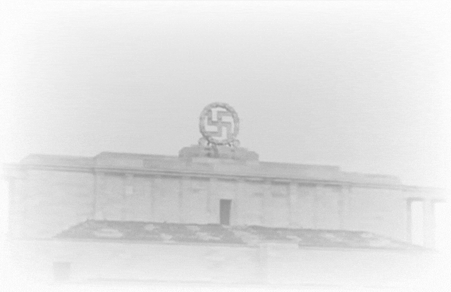 Archival footage of the swastika above the Nazi party rally grounds at Nuremberg being destroyed by explosives in 1945, leaving a cloud of smoke